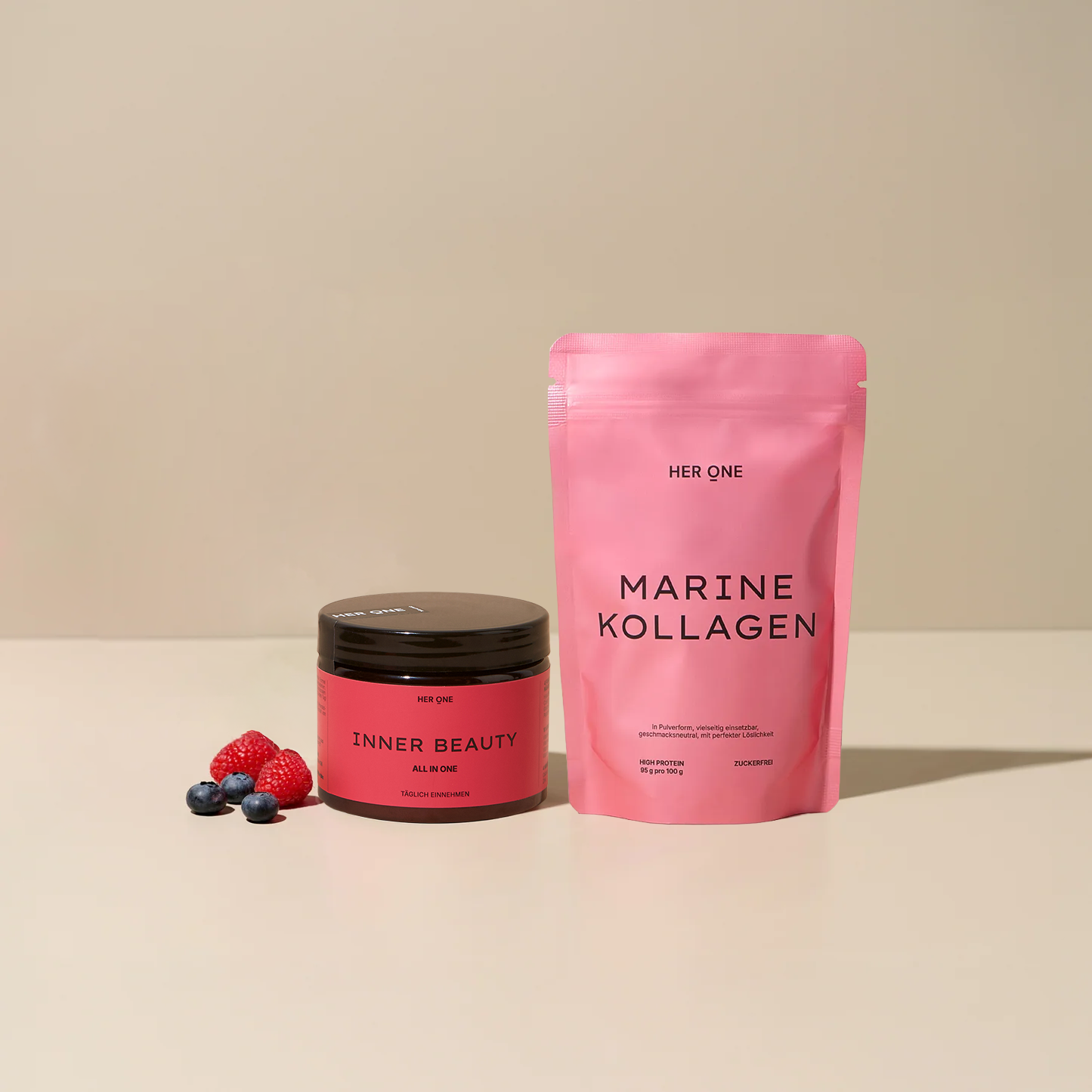 HER ONE INNER BEAUTY Dose und MARINE KOLLAGEN Beutel mit Beeren auf beigem Grund.