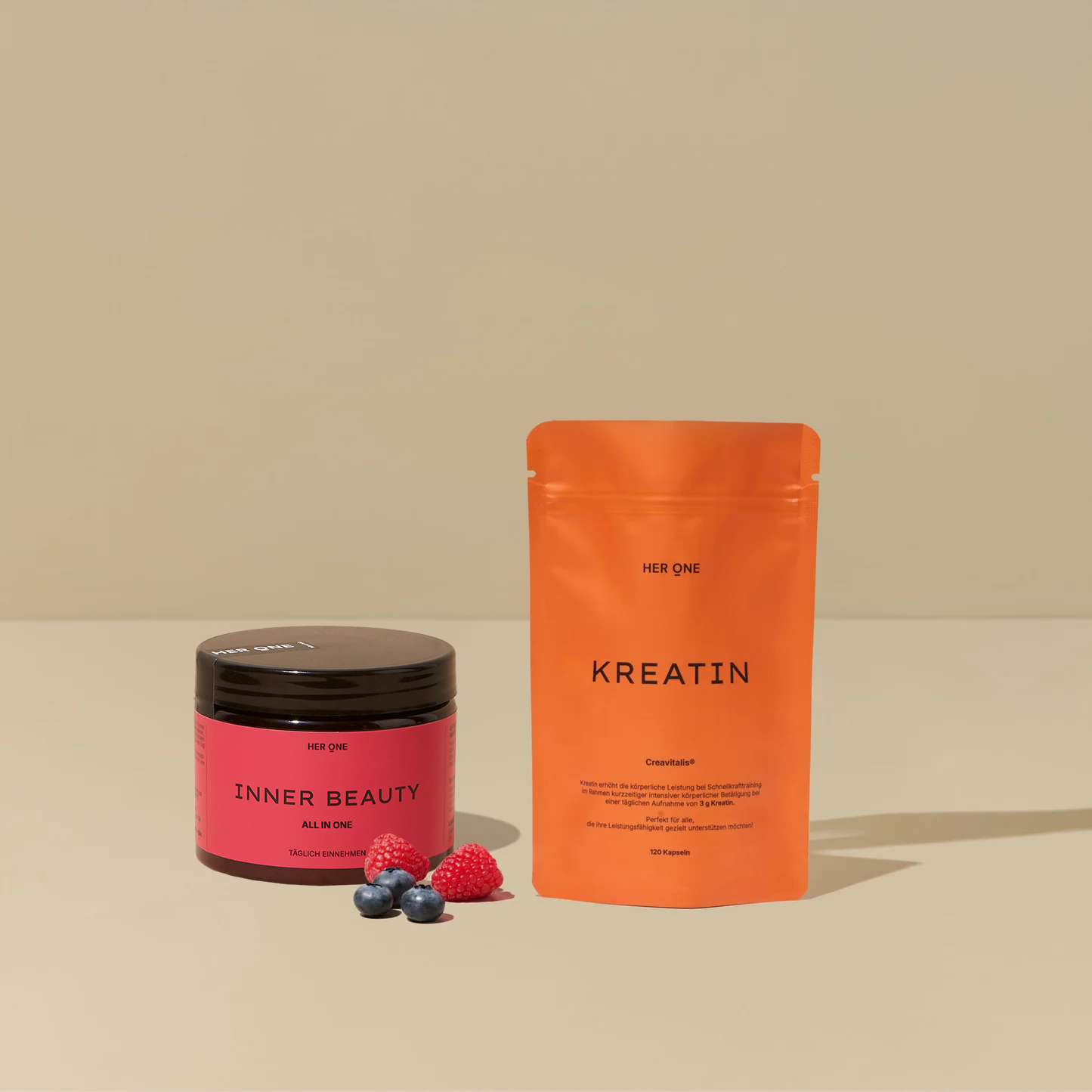 HER ONE INNER BEAUTY tin and KREATIN bag with berries on a beige background.
