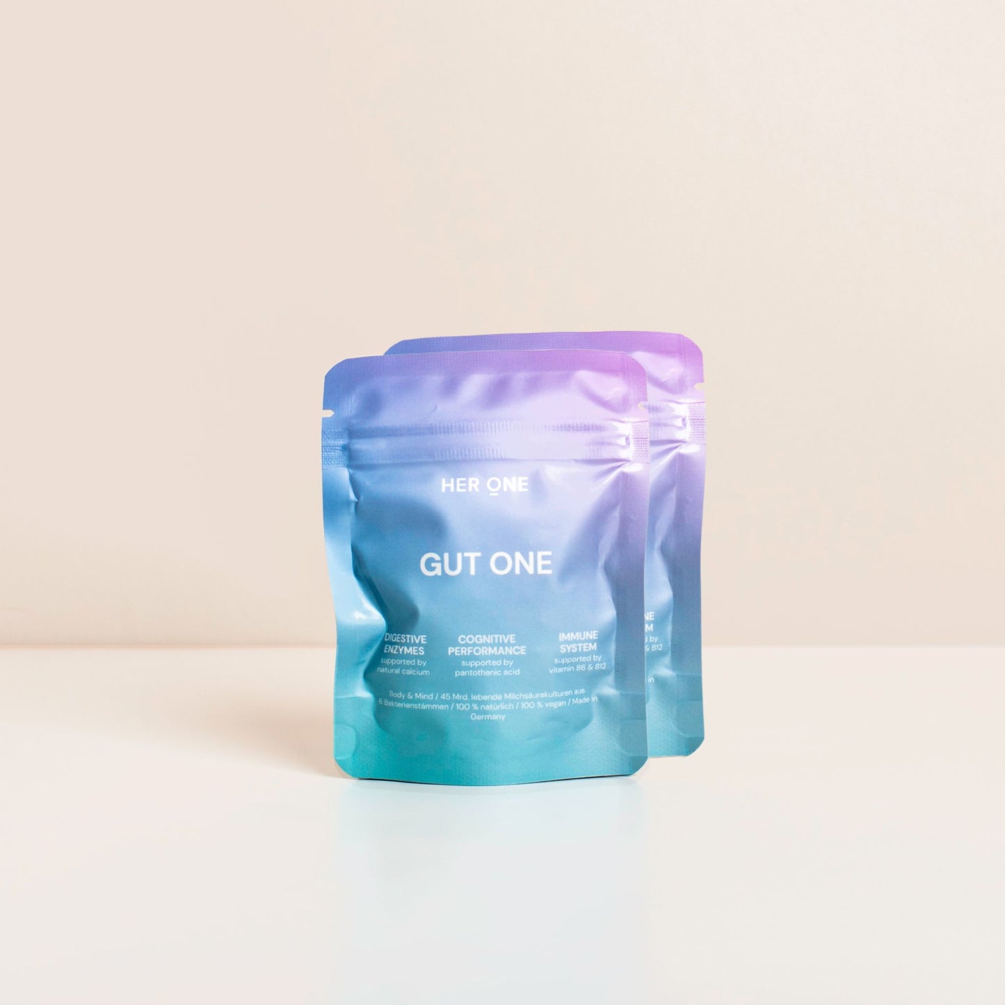 Due confezioni di colore azzurro e viola con la scrittaGUT ONE" su sfondo bianco.