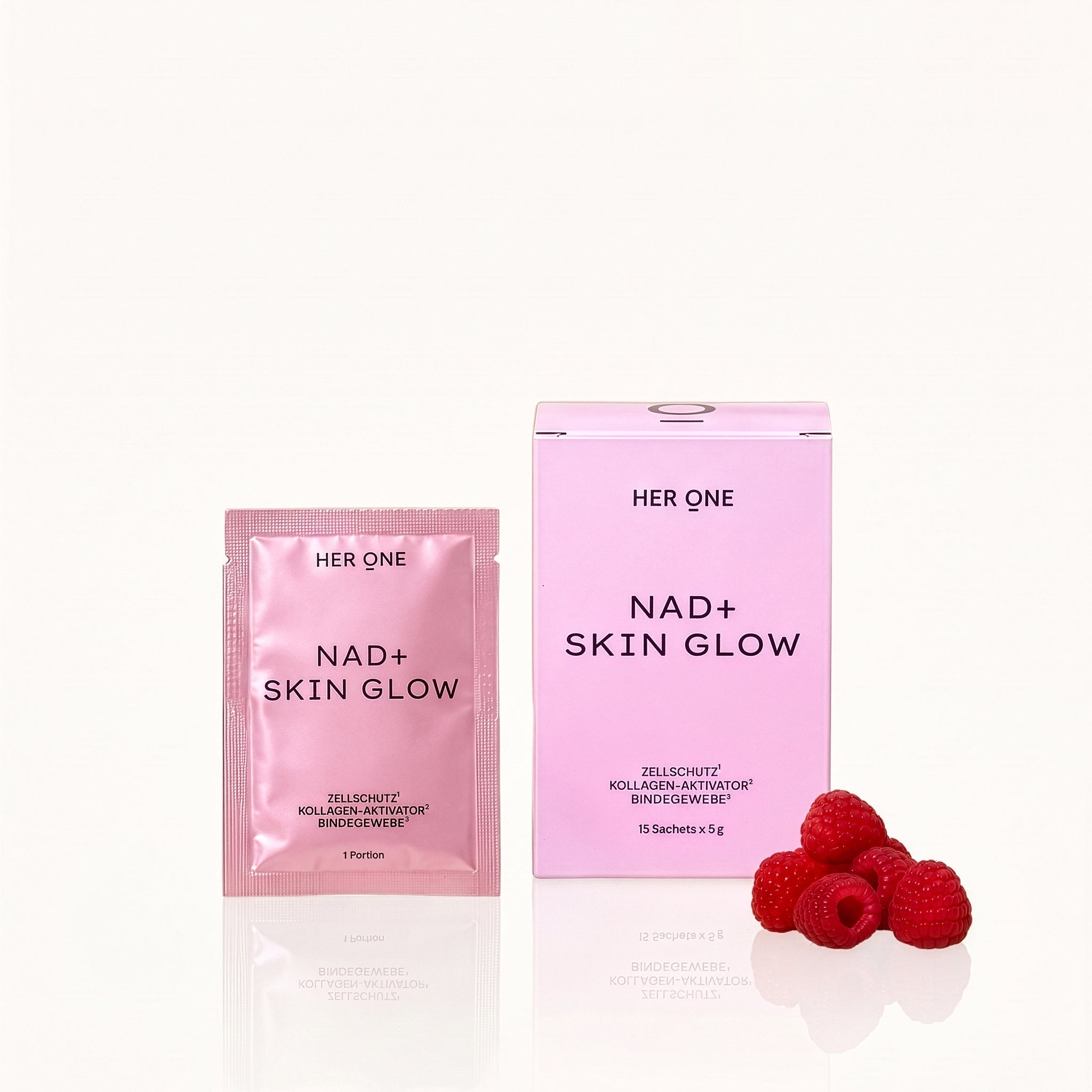 HER ONE NAD+ Skin Glow Packaging featuring a pink raspberry drink in a glass and fresh raspberries.