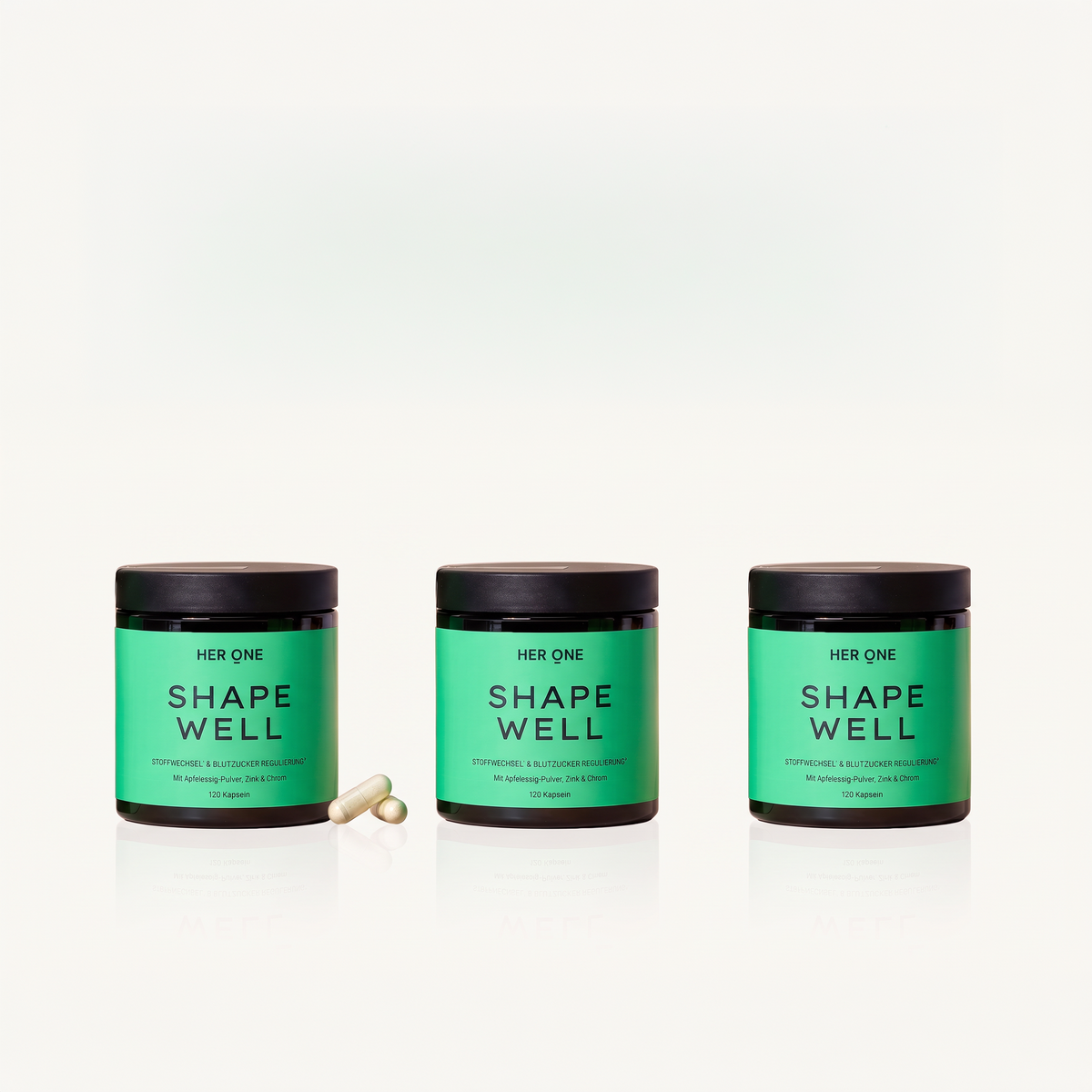 Drei grüne Dosen mit der Aufschrift "Shape Well" und zwei Kapseln davor auf weißem Hintergrund.