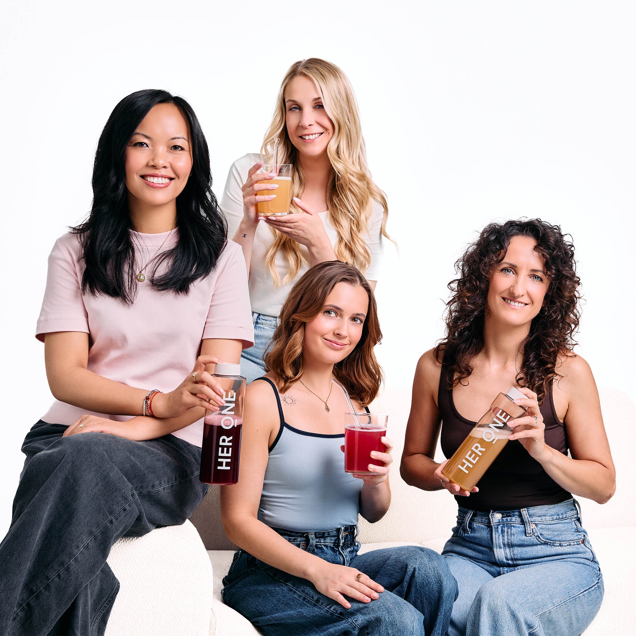 Women holding HER ONE Inner Beauty AIO drinks