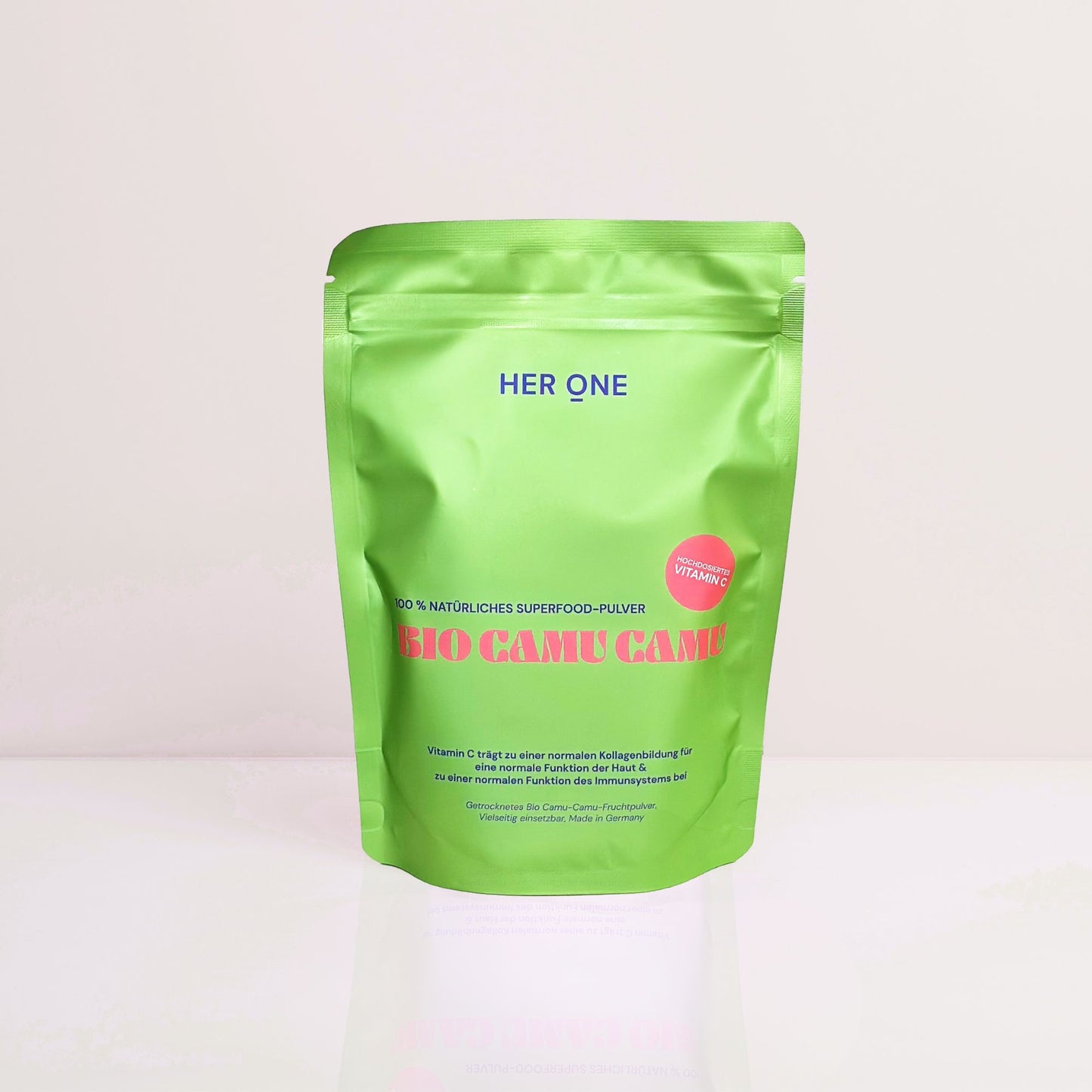Green packaging of an organic superfood powder called "Bio Camu Camu" from "Her One" with a reference to vitamin C.