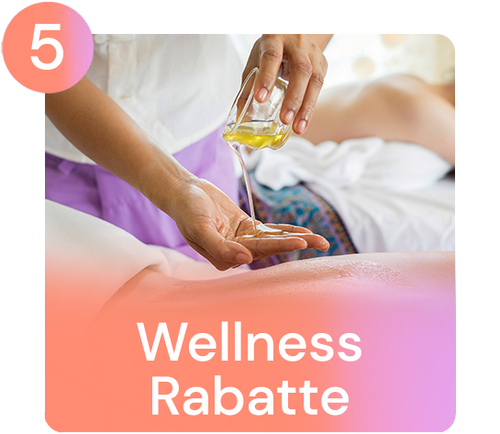 Person pouring massage oil onto a hand, a massage table in the background. text: "Wellness discounts".