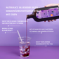 Bottle of berry drink is poured into a glass with ice cubes on a purple background, accompanied by product text.