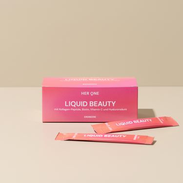 Pink box and two sachets with the inscription "Liquid Beauty" on a beige background.