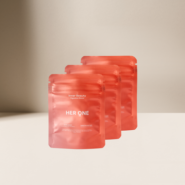 Three red packages with the inscription "HER ONE" on a beige background.