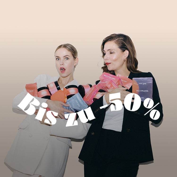 Two women in elegant clothes are holding products in their arms, with the text "Up to -50%" above them.