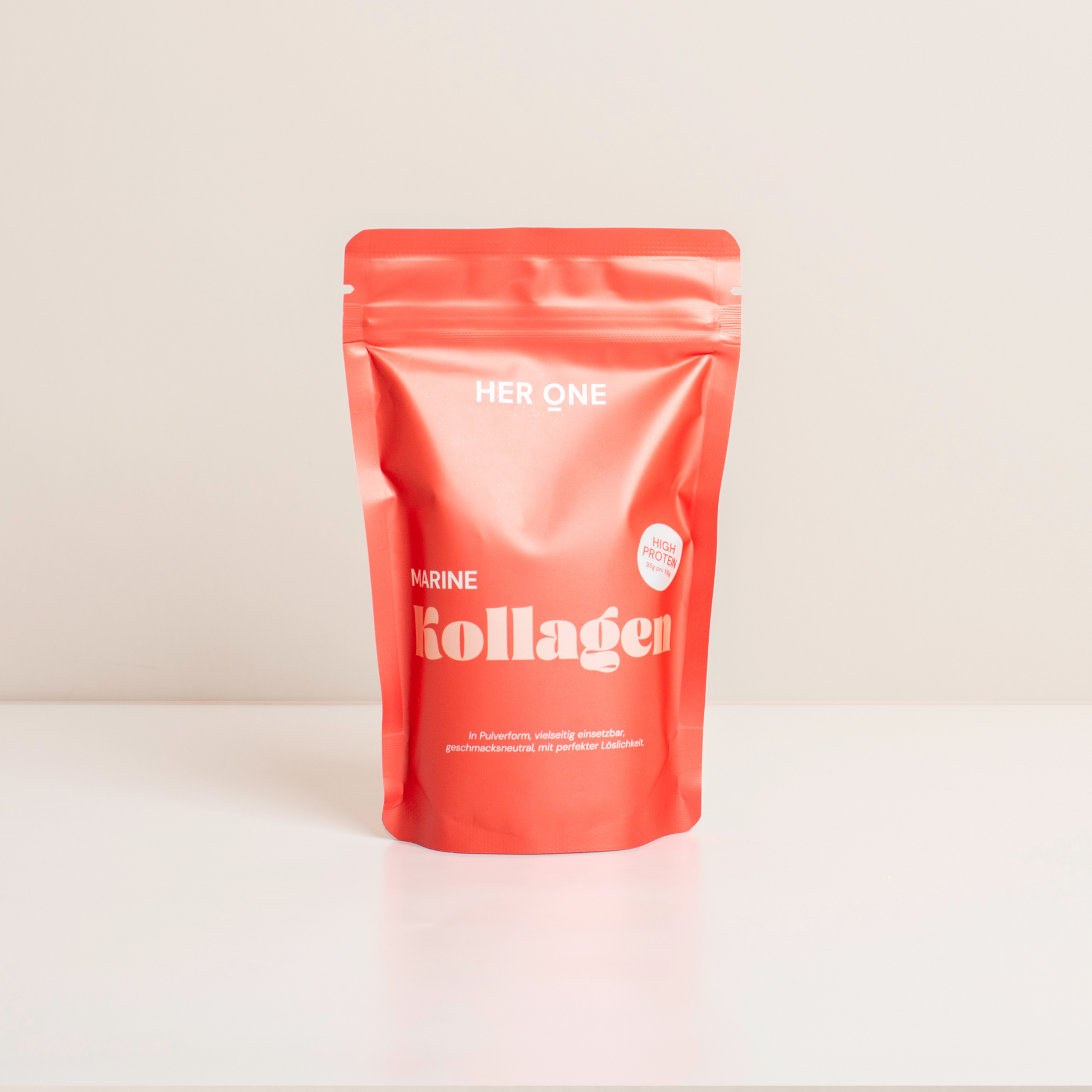 Red packaging of "Her One Marine Collagen" on a white background with the text "High Protein" printed on it.
