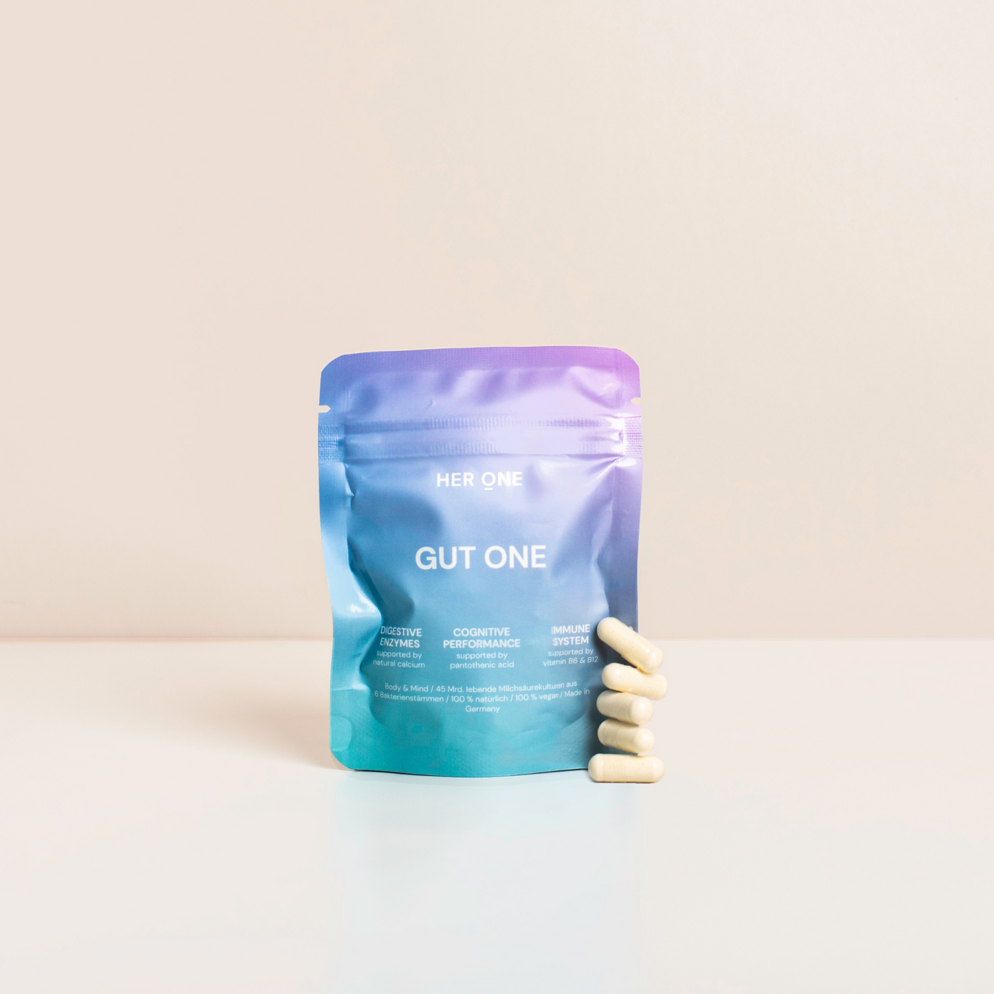 Colorful packaging ofGut One" with six capsules in the foreground on a white background.