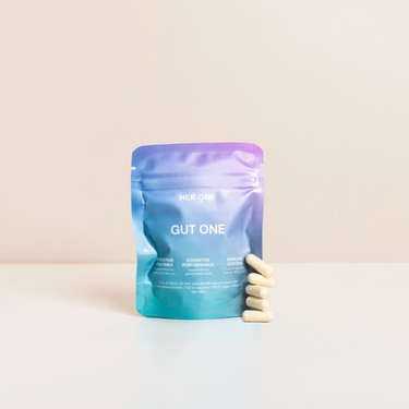 Colorful packaging ofGut One" with six capsules in the foreground on a white background.