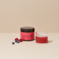 A glass of pink drink, a jar ofINNER BEAUTY", raspberries, blueberries and a golden spoon with powder.