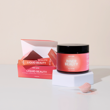 Box with Liquid Beauty sticks and Inner Beauty next to it, on a white background with pink powder in a spoon.
