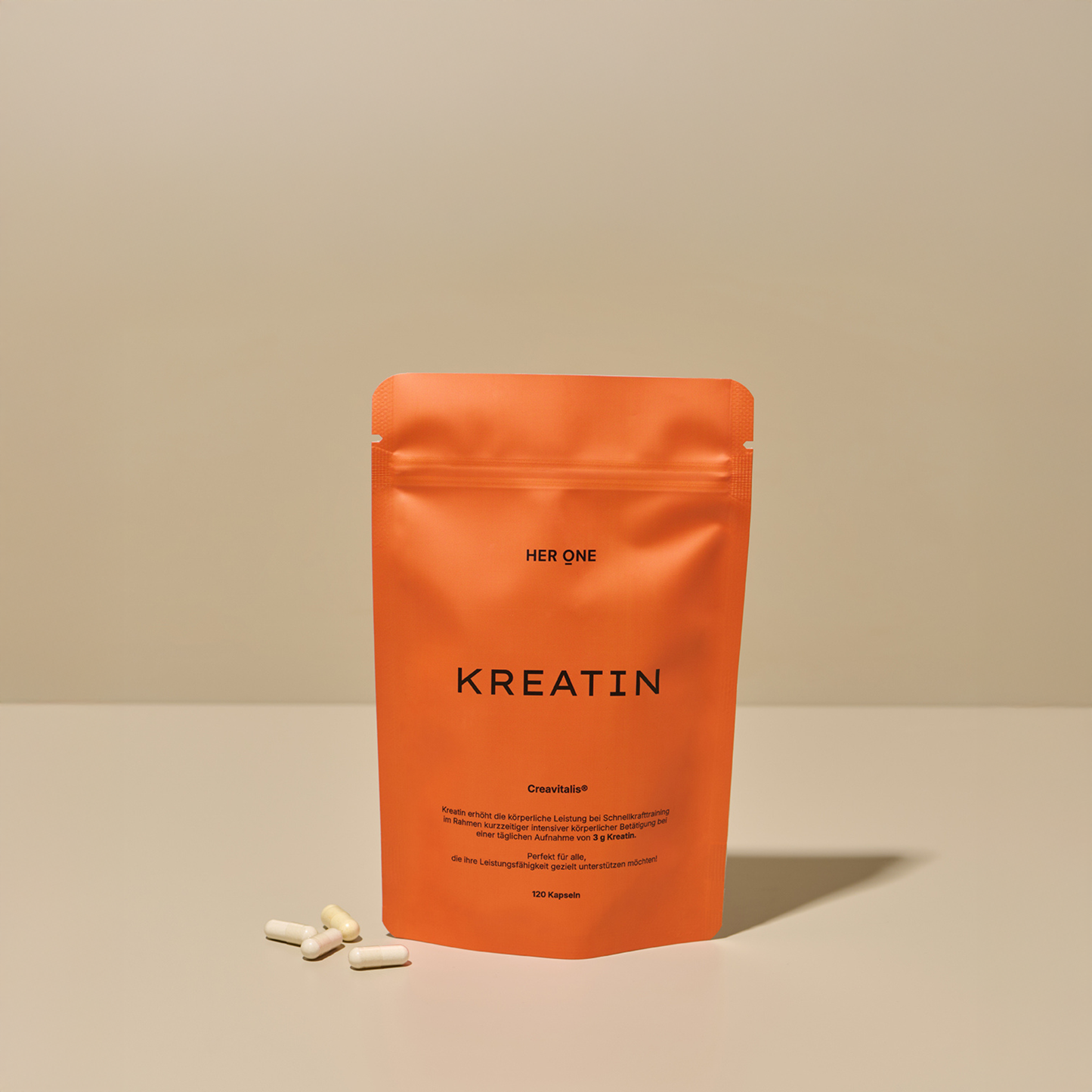 Orange bag HER ONE CREATINE capsules to boost physical performance.