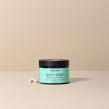 Una confezione di HER ONE GUT ONE etichetta verde menta, coperchio nero e 60 capsule.