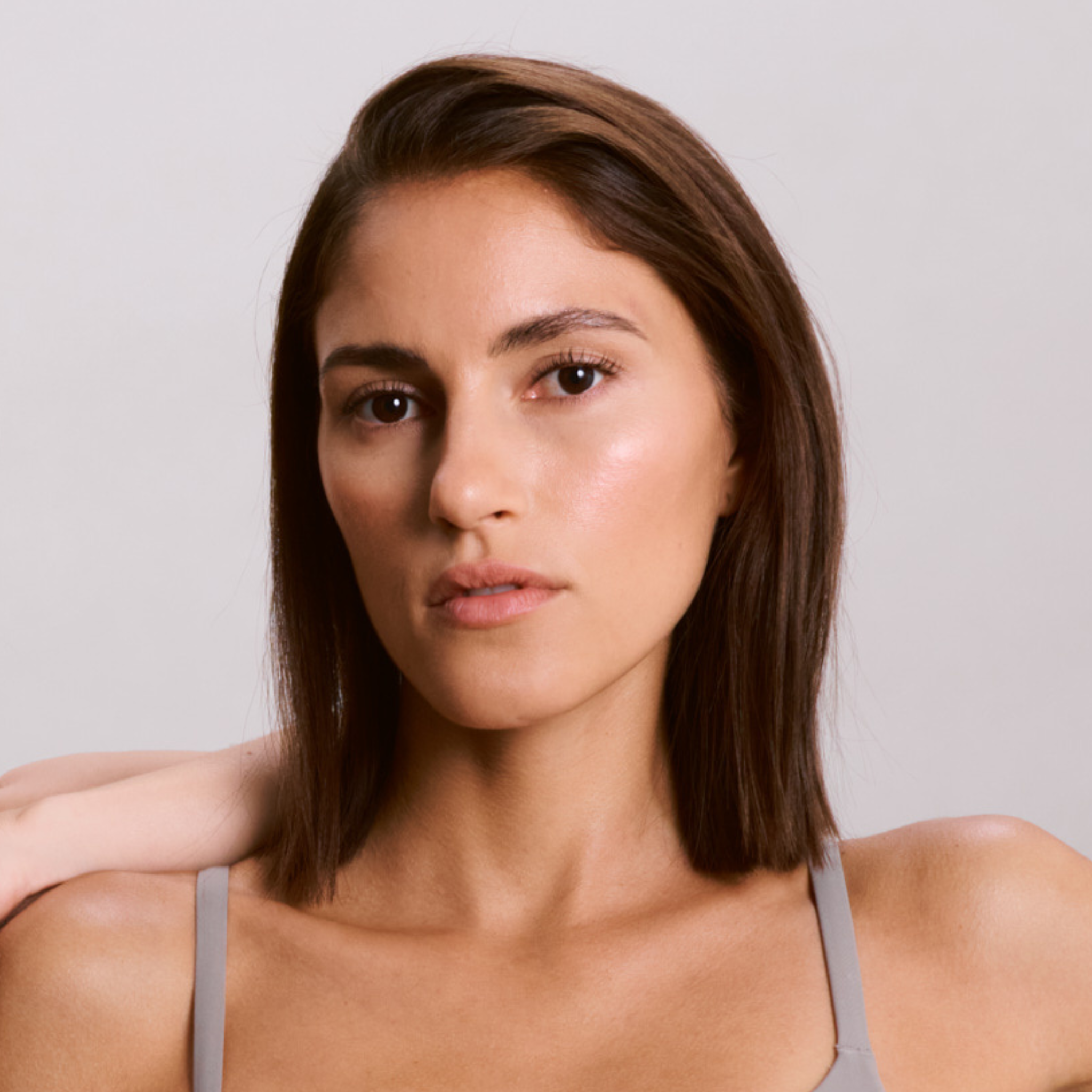 Primo piano di una donna dall'aspetto naturale e dalla pelle curata, simbolo di bellezza naturale.