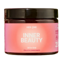Een bruin potje met een roze etiket van het merk "Her One", met de tekstInner Beauty" en "Take daily".